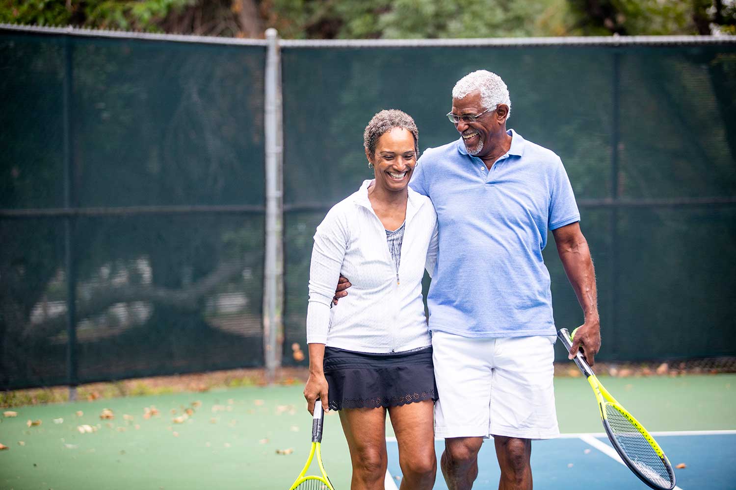 WaterSong active adult couple playing tennis